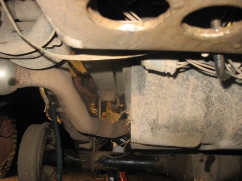 1988 Ford Bronco - Close-up of vehicle undercarriage, focusing on exhaust and suspension parts.