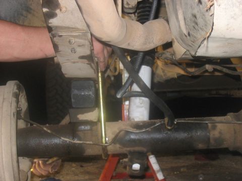 1988 Ford Bronco - Close-up of the undercarriage, focusing on the suspension components and exhaust pipe.
