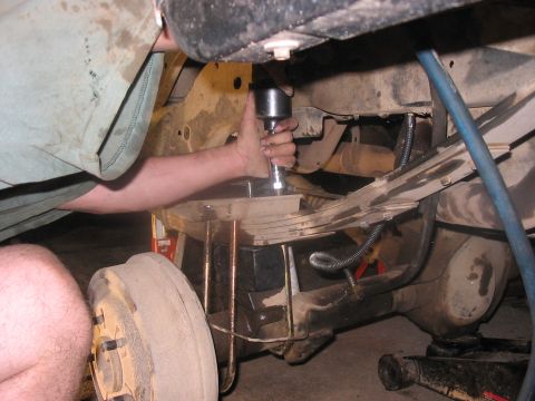 1988 Ford Bronco - Mechanic installs lift kit components on a 1988 Ford Bronco's rear axle.
