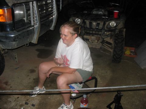 1988 Ford Bronco - A woman sits in a garage between a lifted 1988 Ford Bronco and an ATV.