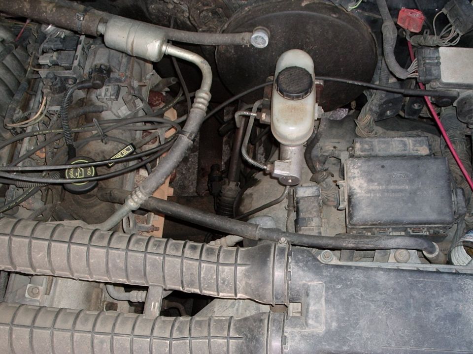 Engine bay with brake fluid reservoir and air intake components