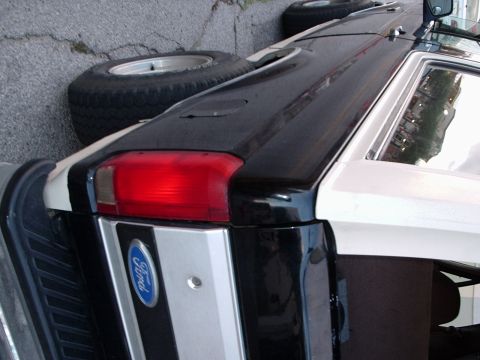 1993 Ford Bronco - This 1993 Ford Bronco features a distinctive black and white paint scheme and a visible spare tire.