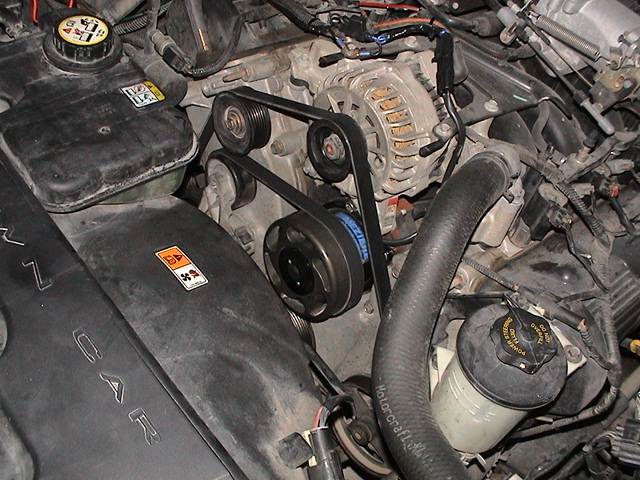 Engine bay view of alternator, serpentine belt and accessory pulleys