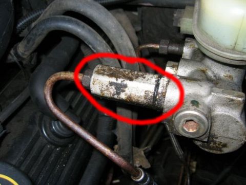 1996 Ford Crown Victoria - Detail of a brake master cylinder, showing a specific part highlighted with a red circle.