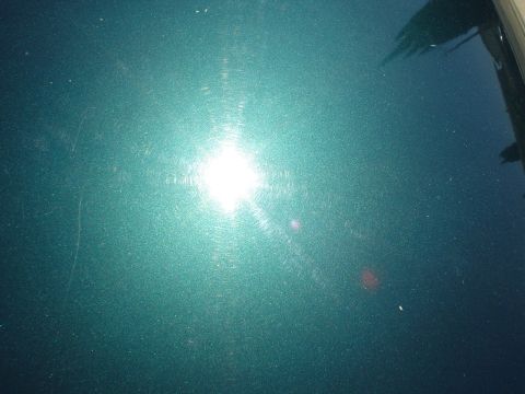 1993 Ford Taurus - The teal paint on this vehicle shows significant swirl marks, indicating it has been polished.