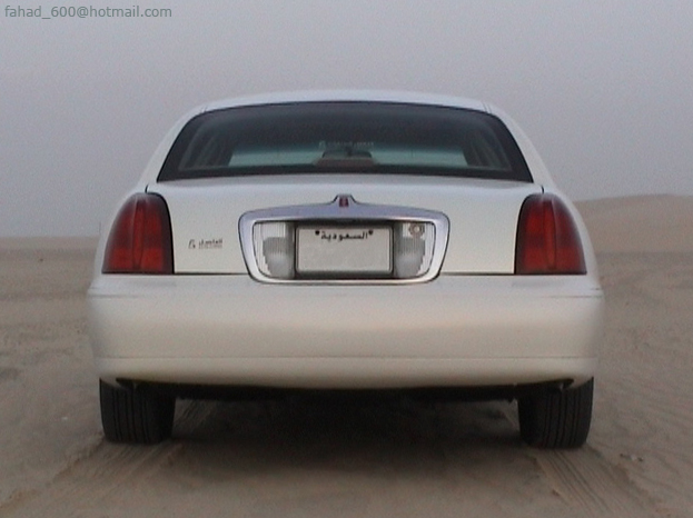 White sedan rear view with Saudi Arabian license plate