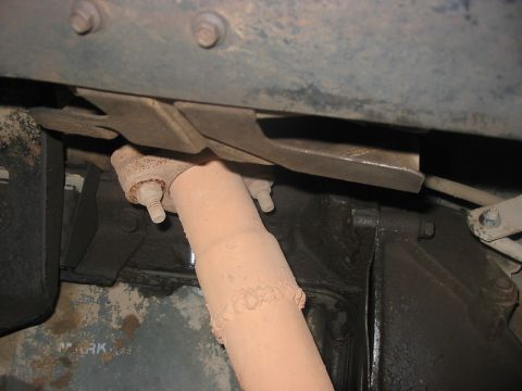 1988 Ford Bronco - Undercarriage view showing a section of exhaust pipe and associated hardware.