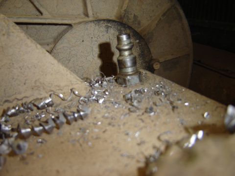 1992 Ford Bronco - Metal shavings are scattered around a quick disconnect fitting, suggesting recent mechanical work.