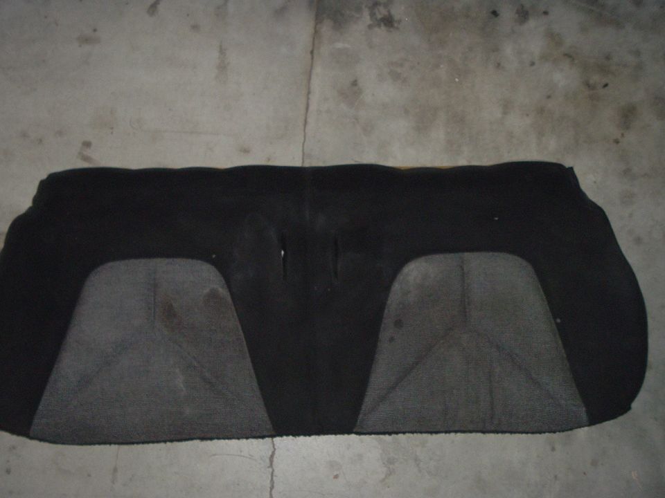 Car seat upholstery with two gray sections on a black background. Some stains are visible