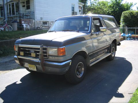 1979 Ford Bronco - This two-tone Ford Bronco is parked in a residential driveway on a sunny day.