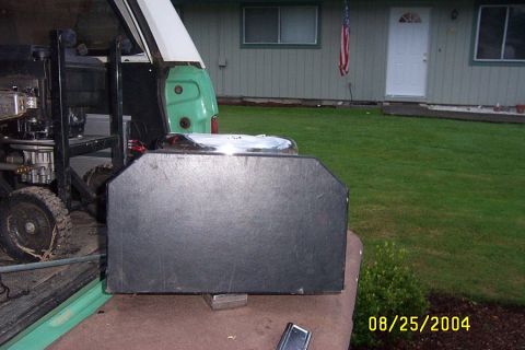 1996 Ford Bronco - Generator with wheels and engine is loaded into the bed of a green truck.
