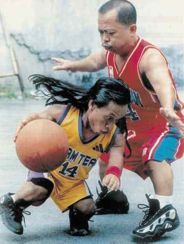 1993 Ford Bronco - Two individuals engage in a game of basketball on an outdoor court.