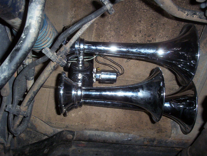 Dual chrome air horns mounted in engine bay