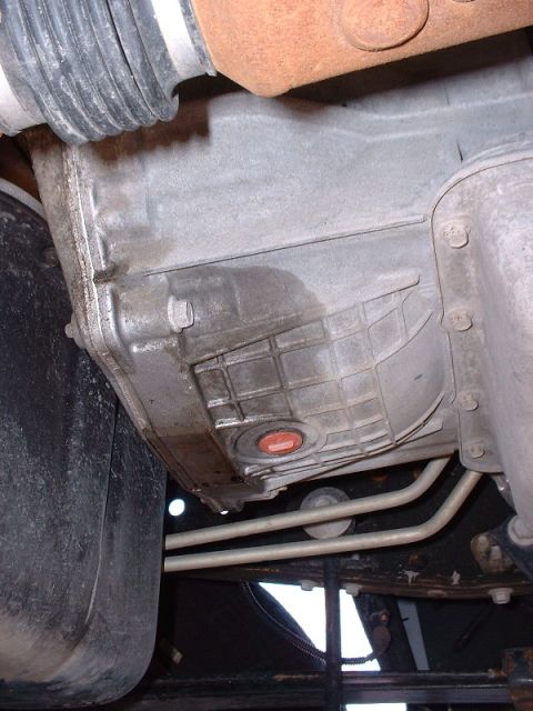 2003 Ford Excursion - Visible oil leak on the underside of a vehicle's transmission pan.