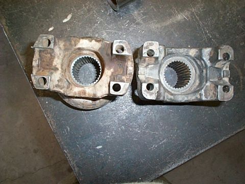 1994 Ford Bronco - Comparison of two driveshaft U-joint yokes, one appears more worn than the other.