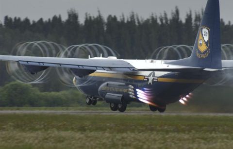 1988 Ford Bronco - A United States Marines C-130 Hercules aircraft takes off with its engines firing, creating visible vortex rings.