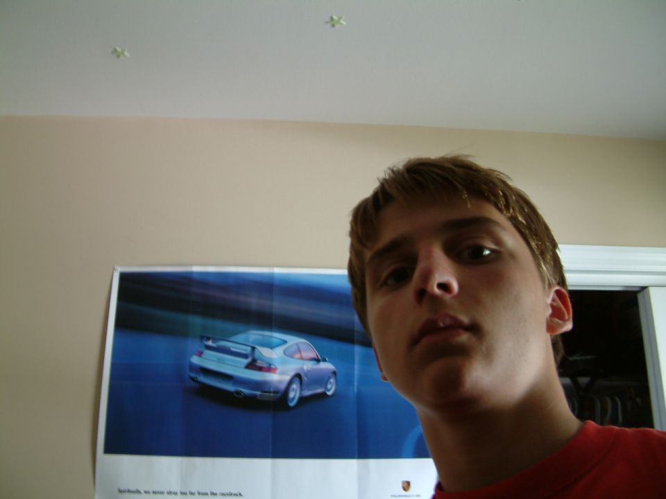 Poster of a silver Porsche 911 with a rear spoiler, viewed from the rear