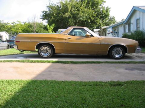 1974 Ford Ranchero - A side view of a gold Ford Ranchero pickup truck parked on a concrete driveway.