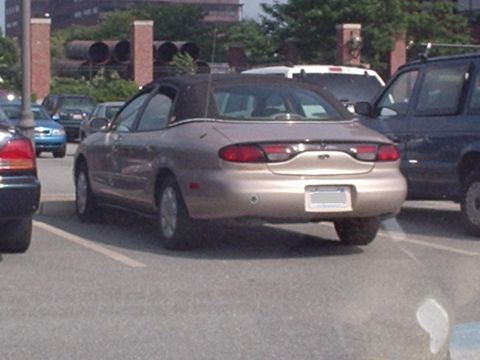 1998 Ford Taurus - Rear view of a tan 1998 Ford Taurus convertible sedan parked in a lot.