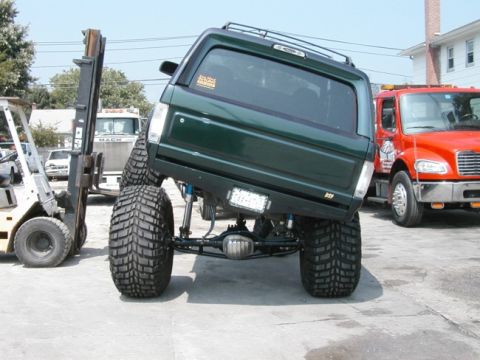 1994 Ford Bronco - Modified 1994 Ford Bronco with extreme lift and tires, seen with other vehicles.