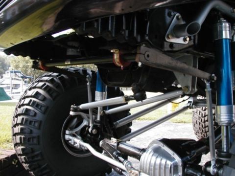 1994 Ford Bronco - Close-up of the suspension and drivetrain components on a heavily modified off-road vehicle.