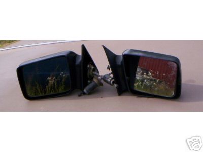 1995 Ford Bronco - A pair of black side mirrors are shown, detached from a vehicle and placed on a surface.