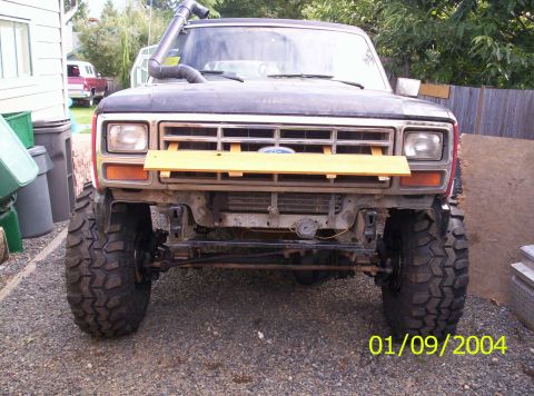 1983 Ford Bronco - This lifted Ford Bronco features a snorkel and aggressive off-road tires, with a temporary wooden piece attached to the front grille.