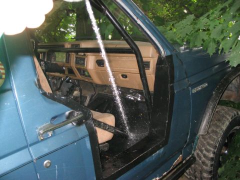 1986 Ford Bronco - Interior view of a 1986 Ford Bronco with a roll cage installed.