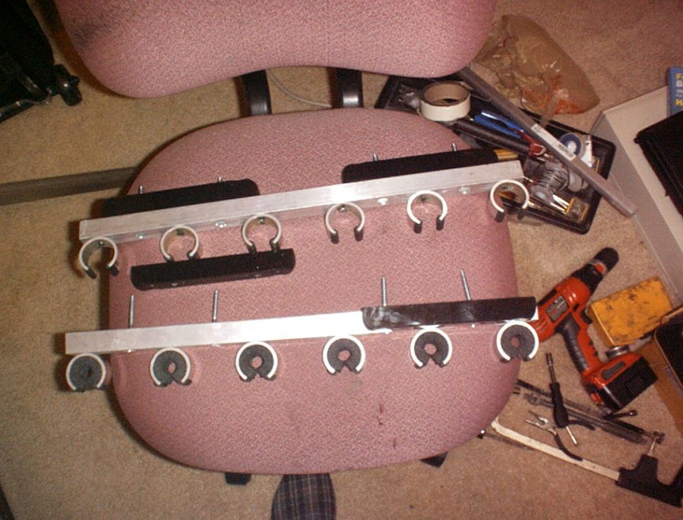 Rod holder attached to a pink office chair with tools nearby