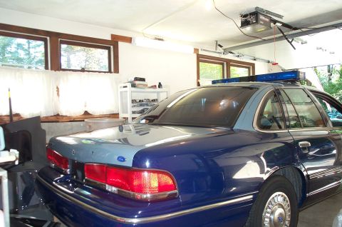 1991 Ford LTD Crown Victoria - Rear view of a 1991 Ford Crown Victoria LTD police car inside a garage.