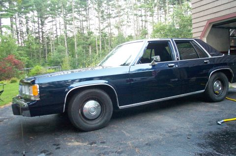 1991 Ford LTD Crown Victoria - A dark blue 1991 Ford Crown Victoria LTD sedan is parked in a driveway.