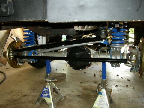 1995 Ford Bronco - Vehicle's rear axle and suspension components are visible, supported by jack stands.