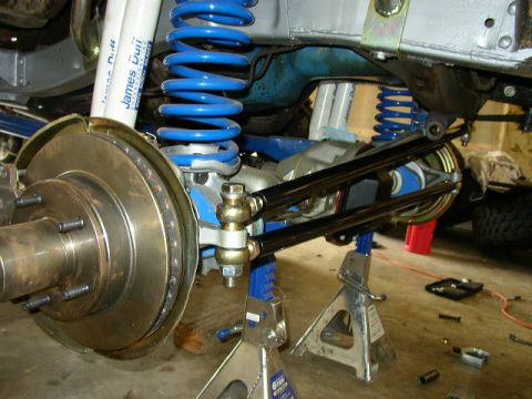 1995 Ford Bronco - The vehicle's suspension system is undergoing maintenance, with components like shocks, springs, and brake rotors visible.