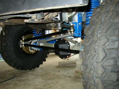 1995 Ford Bronco - Close-up view of a vehicle's modified rear axle and suspension system.