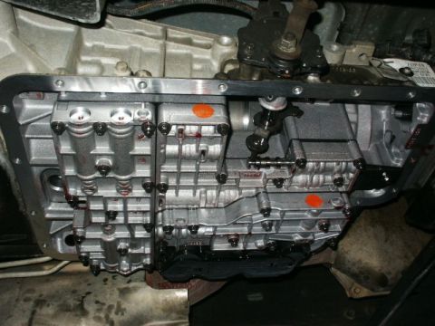 1996 Ford Bronco - Close-up view of a transmission pan gasket, showing signs of fluid leakage.