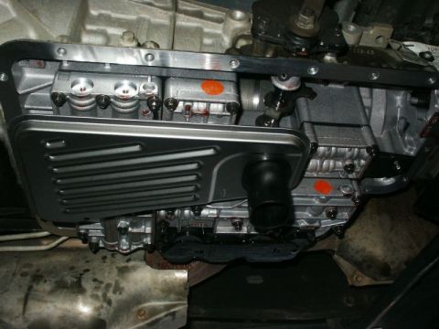 1996 Ford Bronco - Close-up view of a vehicle's transmission pan and filter assembly.