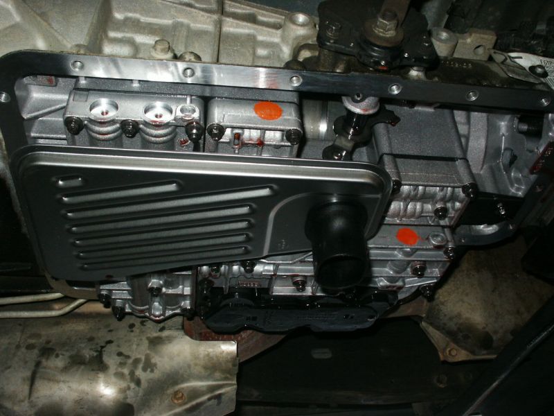 Transmission pan and filter removed, showing internal components and fluid