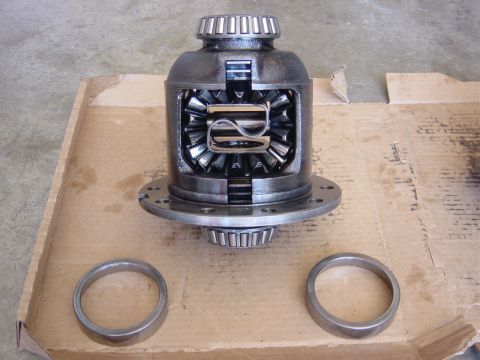 1990 Ford Bronco - A differential assembly and two rings are laid out on a cardboard box.