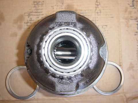 1990 Ford Bronco - Close-up of a differential carrier assembly, the Ford logo and a bearing.