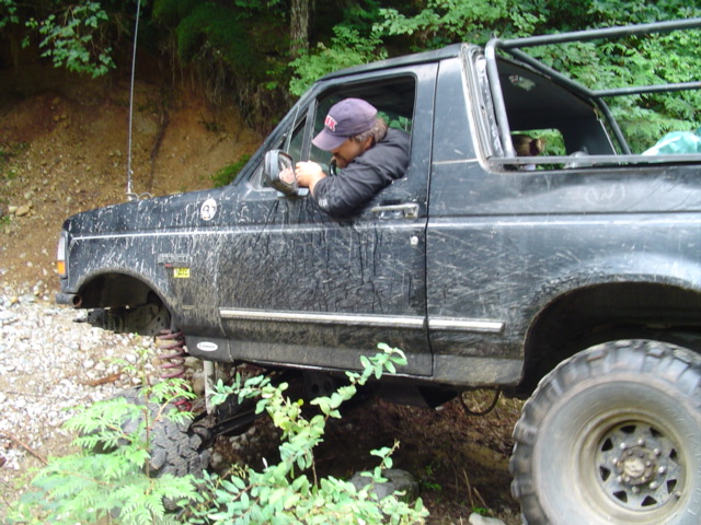 Side view of a black 1993 Ford Bronco off-roading