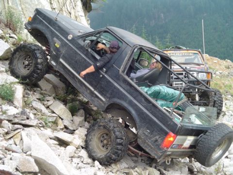 1993 Ford Bronco - This 1993 Ford Bronco is tackling a steep, rocky trail with a second vehicle in the background.