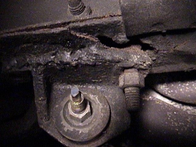 Rusty metal steering bracket with bolts and nuts