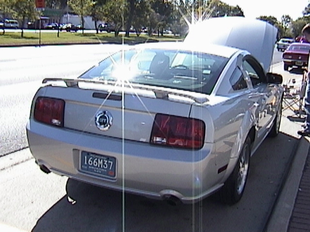 Silver Ford Mustang GT coupe, rear three-quarter view with spoiler and dual exhaust