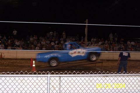 1979 Ford Bronco II - A blue pickup truck with custom graphics is seen in action at an event.