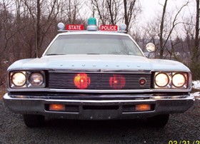 1991 Ford Crown Victoria LTD - This police car features a prominent light bar and "STATE POLICE" signage on the roof.