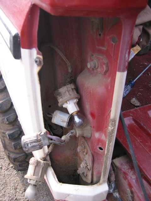 1985 Ford Bronco - Disconnect all the plugs and squeeze the Grommet and push it through the hole.