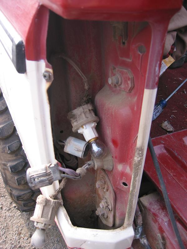 Disconnect all the plugs and squeeze the Grommet and push it through the hole.