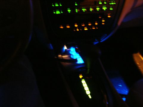 2000 Ford Taurus - The illuminated dashboard and gear shifter glow in the dark interior of a vehicle.