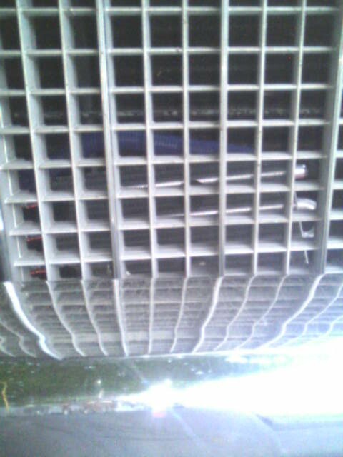 1987 Lincoln Town Car - Close-up view of a car's front grille, showing its intricate grid design.