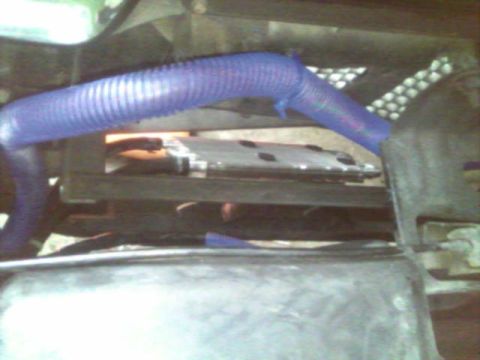 1987 Lincoln Town Car - Engine bay detail showing a blue hose and some metal components.